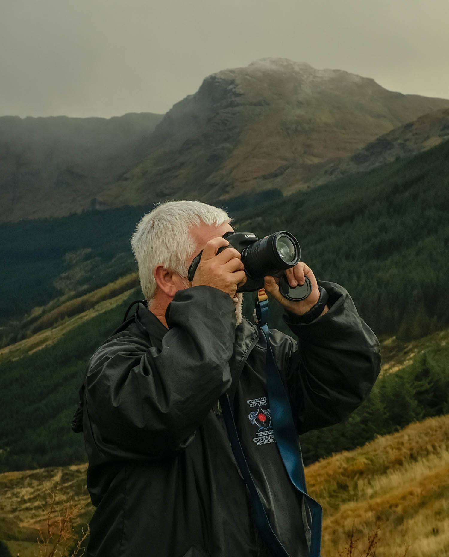 Photograph of a man taking photographs in the mountains
